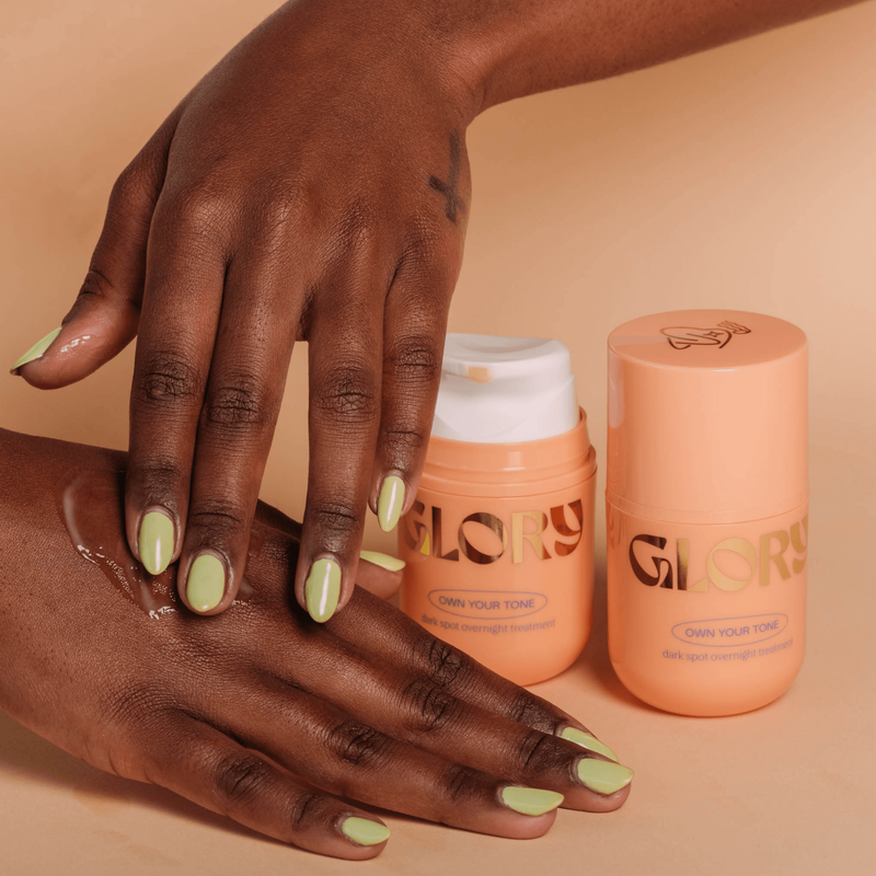 Model applying Own Your Tone Dark Spot Overnight Treatment to  hand